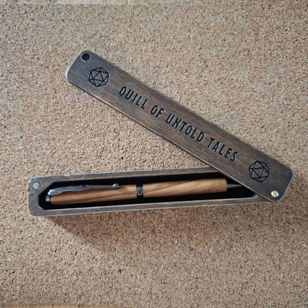 Wooden pen case engraved with the words Quill of Untold Tales